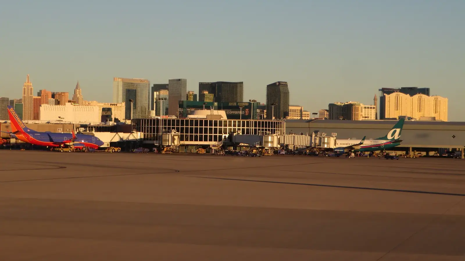 Planes at Harry Reid International Airport with the Las Vegas Strip skyline behind