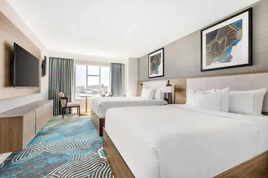 a hotel room with two beds and a television at Hilton Grand Vacations Club Paradise Las Vegas in Las Vegas
