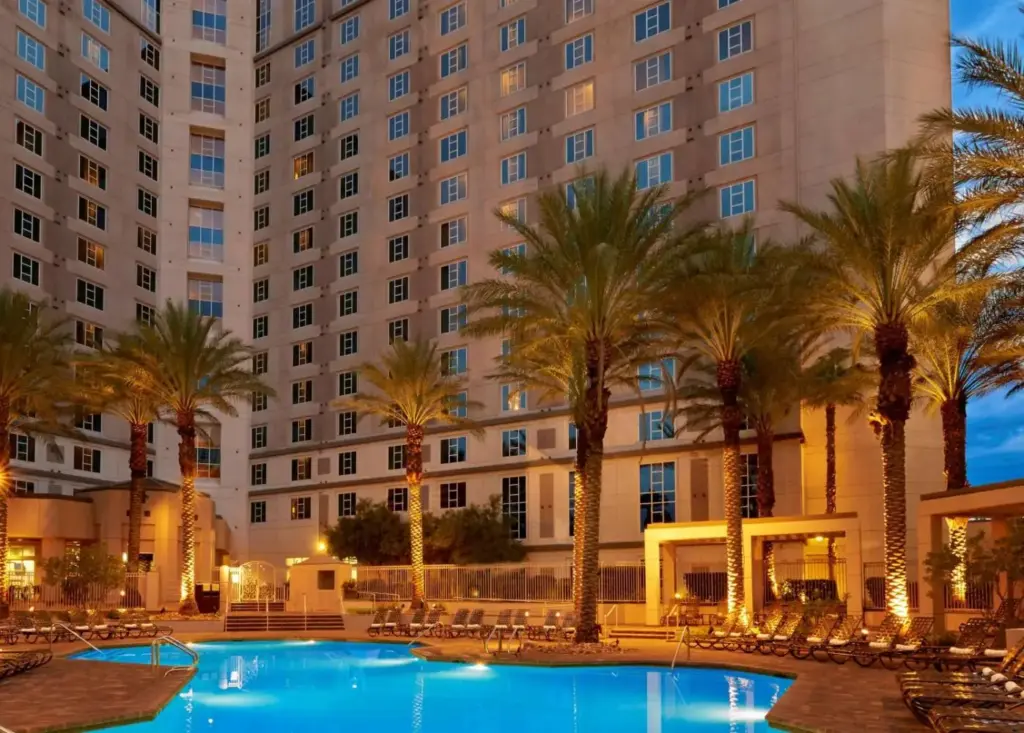 a hotel with palm trees and a large building at Hilton Grand Vacations Club Paradise Las Vegas in Las Vegas
