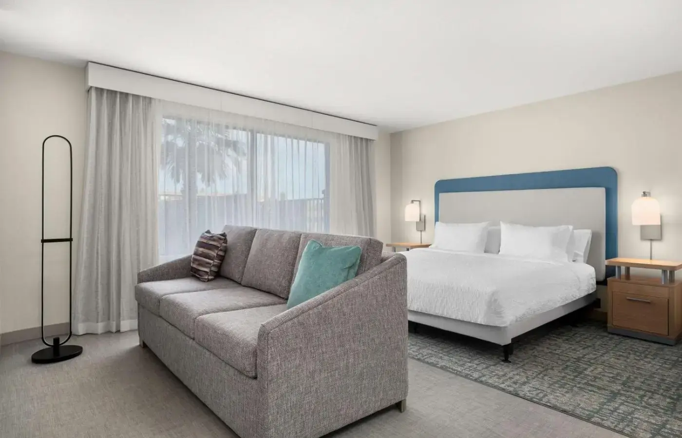 Bed and seating area in a Homewood Suites North Speedway room