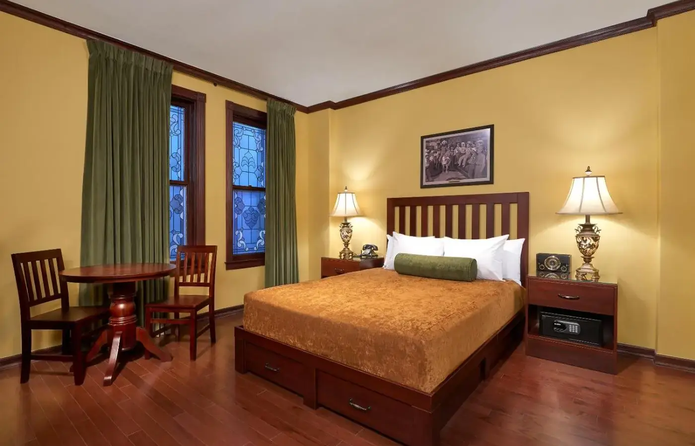 a bedroom with a bed and a table and chairs at Hotel Apache in Las Vegas