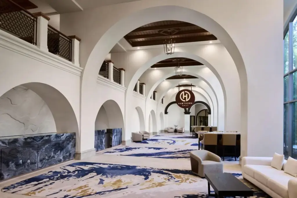 a lobby with white walls and arches and couches at JW Marriott Las Vegas Resort & Spa in Las Vegas
