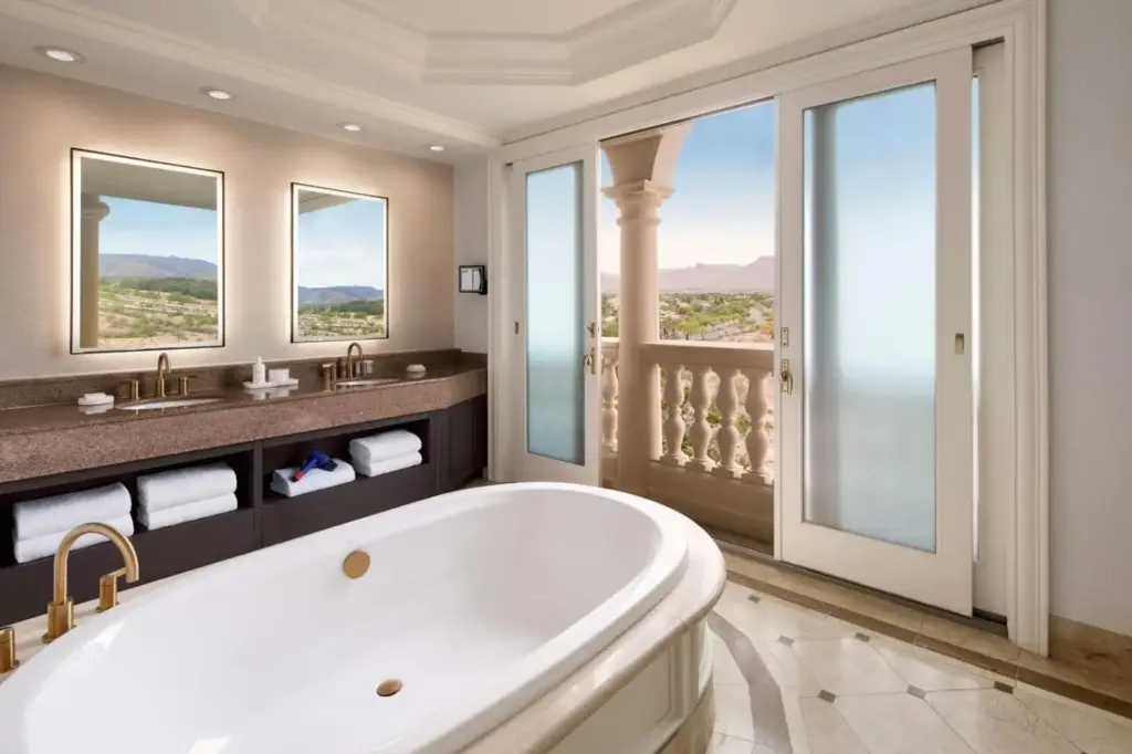 a large bathroom with a tub and a balcony at JW Marriott Las Vegas Resort & Spa in Las Vegas
