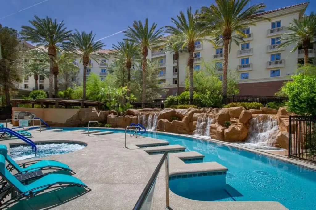 a pool at a resort with a waterfall and slides at JW Marriott Las Vegas Resort & Spa in Las Vegas