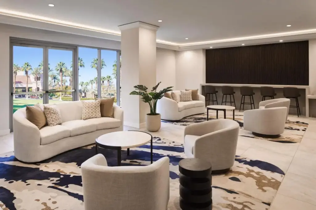 a lobby with couches and chairs and a bar at JW Marriott Las Vegas Resort & Spa in Las Vegas