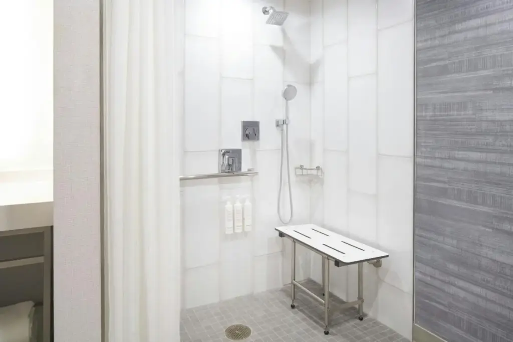 a bathroom with a shower with a stool in it at Las Vegas Marriott in Las Vegas