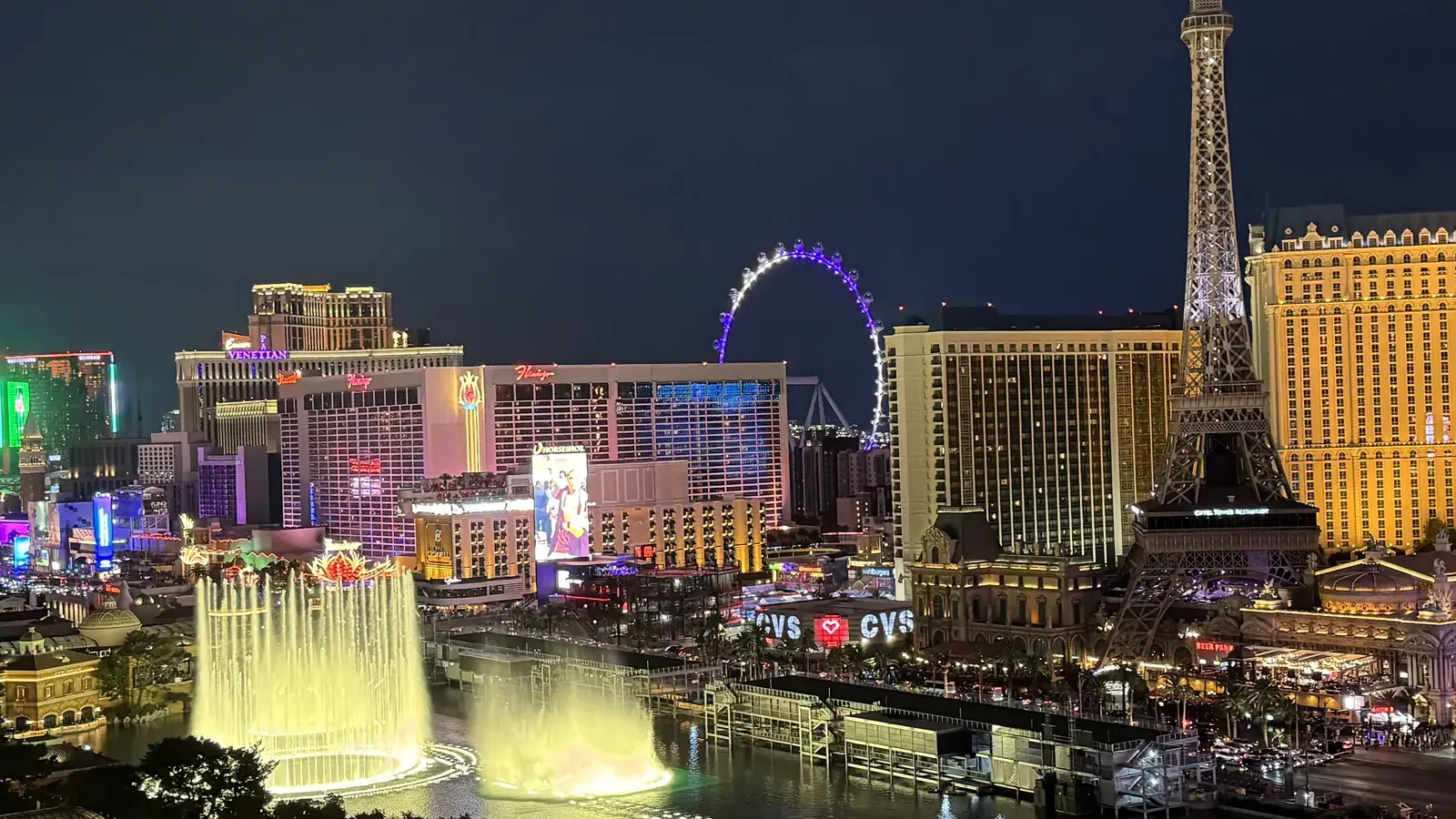 The Las Vegas Strip at night with the Bellagio fountains, Paris Las Vegas and the High Roller