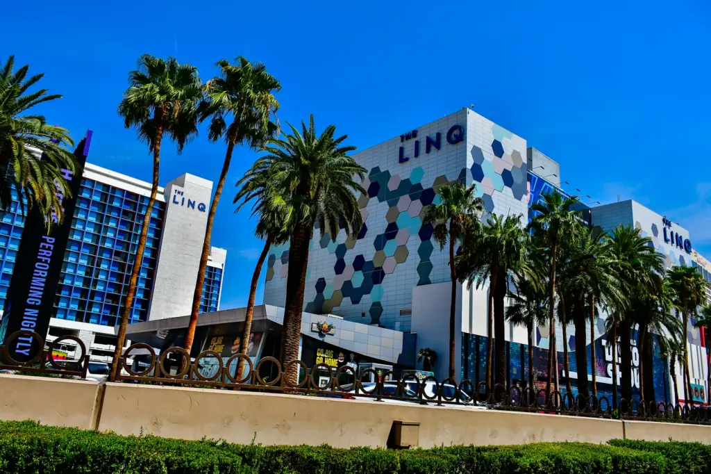 The LINQ Hotel's hexagon-patterned facade and palm trees on the Strip