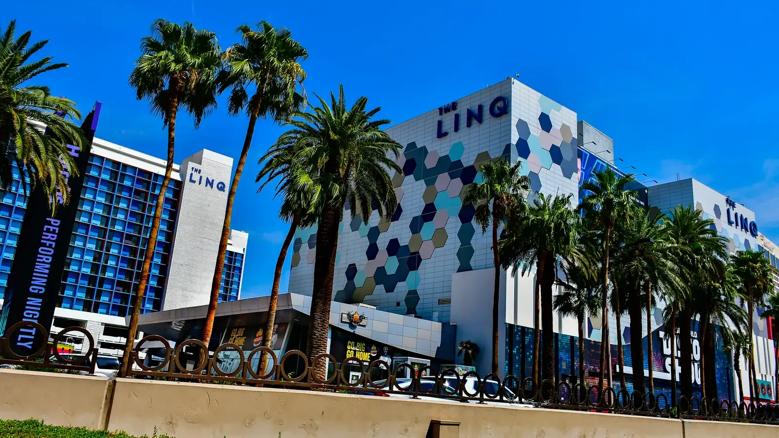 The LINQ Hotel's hexagon-patterned facade and palm trees on the Strip