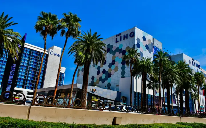 The LINQ Hotel's hexagon-patterned facade and palm trees on the Strip