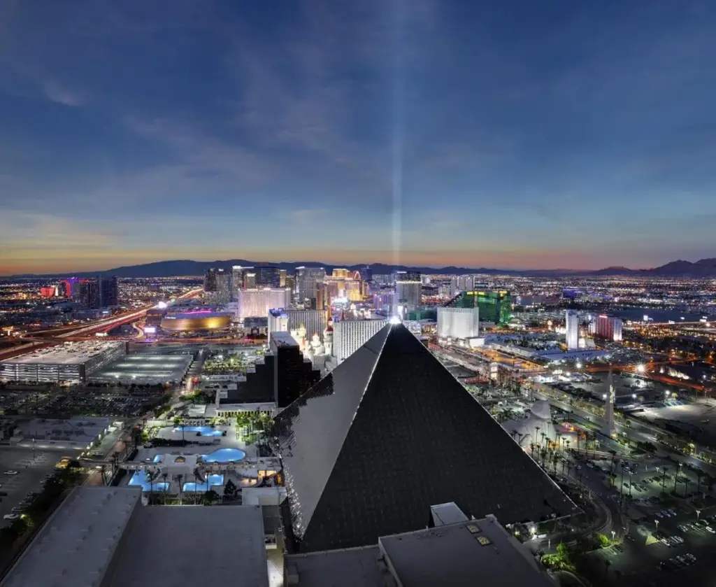 a view of a city at night with a pyramid at Luxor in Las Vegas