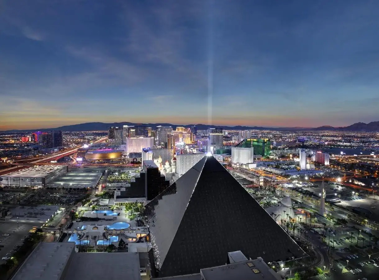 a view of a city at night with a pyramid at Luxor in Las Vegas