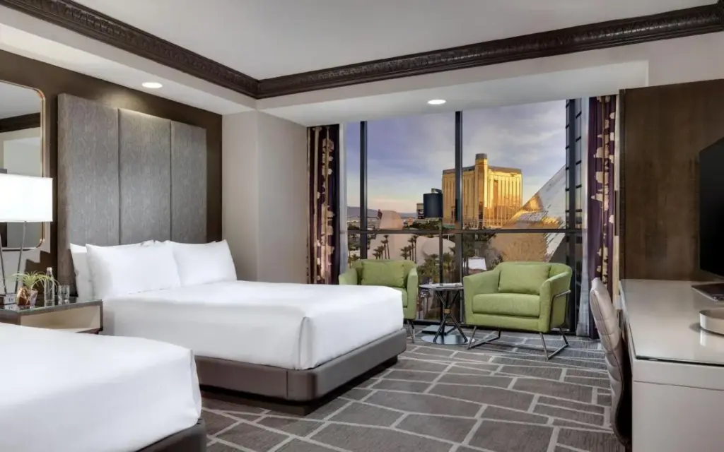 a hotel room with two beds and a balcony at Luxor in Las Vegas