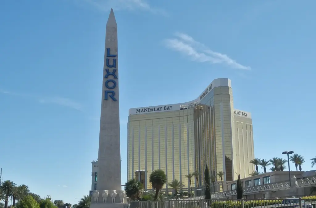 Luxor's obelisk sign in front of the gold Mandalay Bay towers in Las Vegas