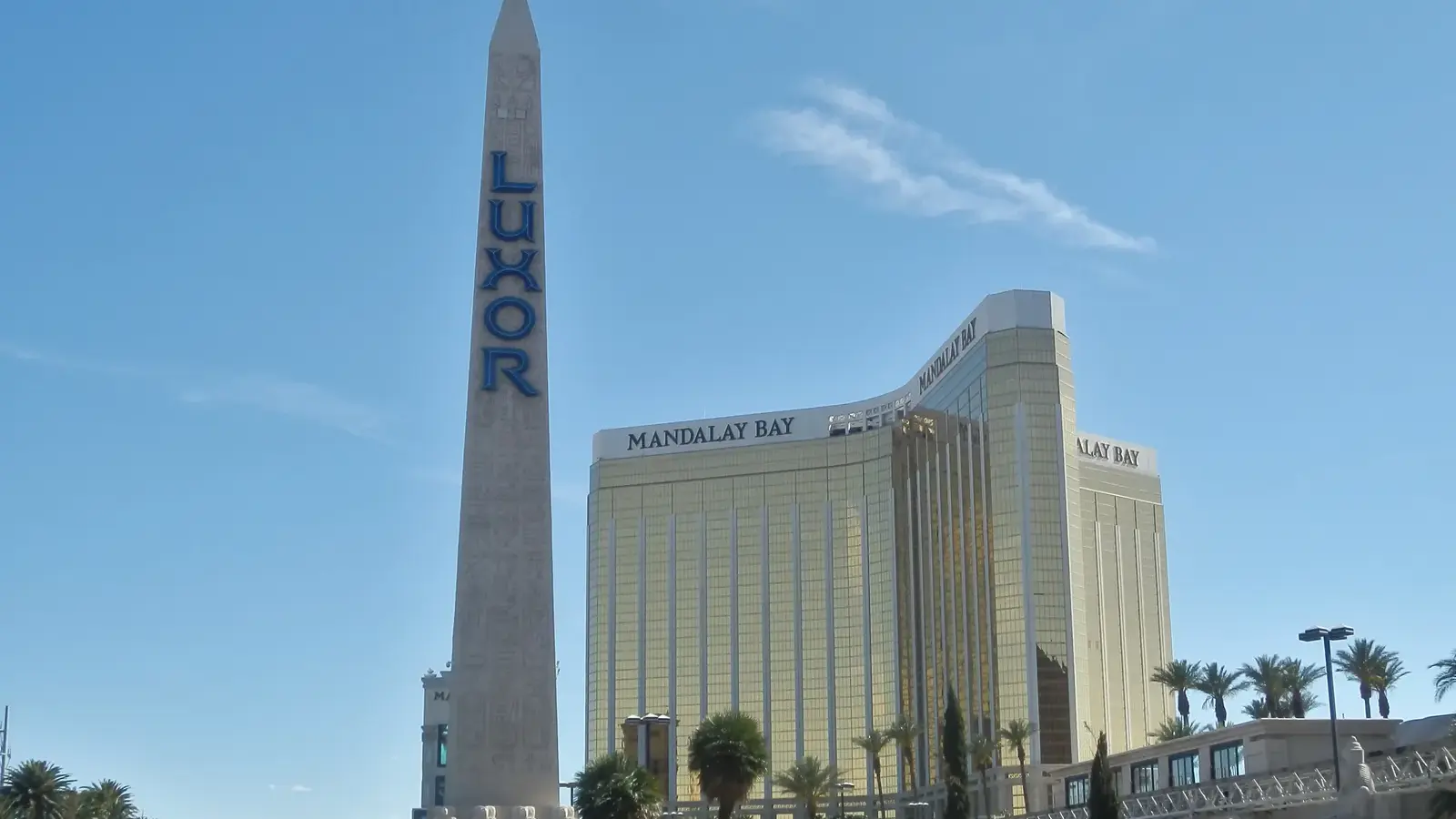 Luxor's obelisk sign in front of the gold Mandalay Bay towers in Las Vegas