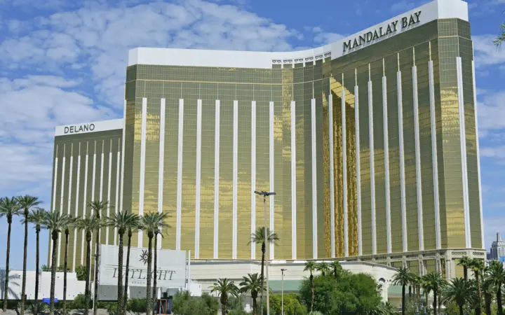 Mandalay Bay's gold glass hotel tower with palm trees