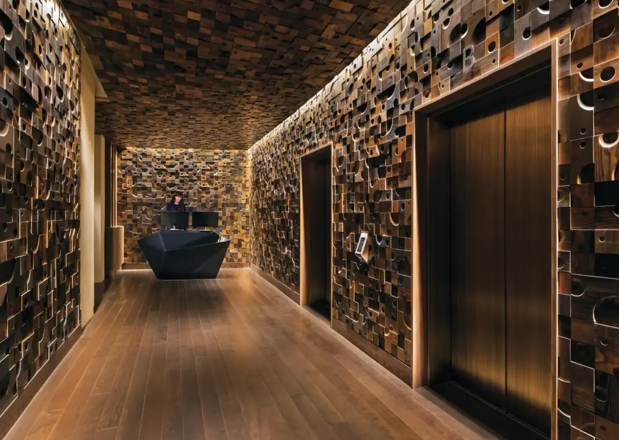 a bathroom with a stone wall and a black door at Nobu Las Vegas, A Caesars Destination in Las Vegas