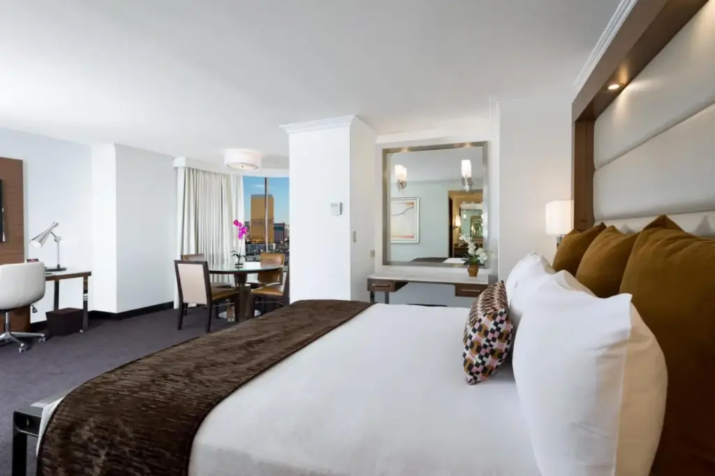 Example Palace Station guest room with a king bed and desk