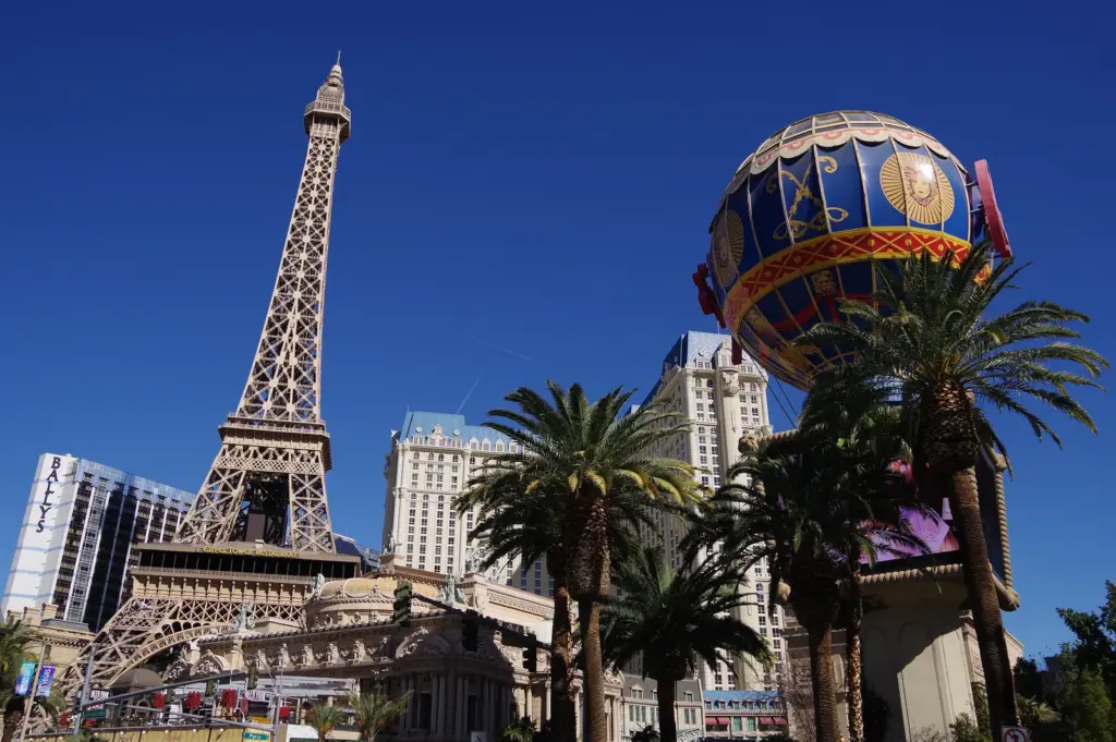 Paris Las Vegas Eiffel Tower replica and balloon sign under a blue sky