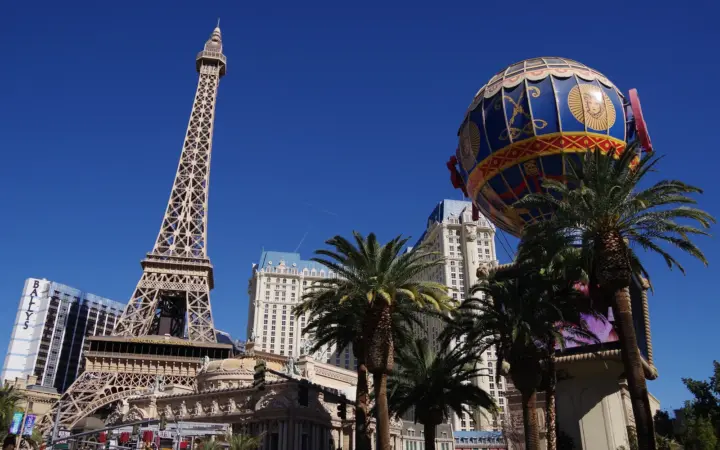 Paris Las Vegas Eiffel Tower replica and balloon sign under a blue sky