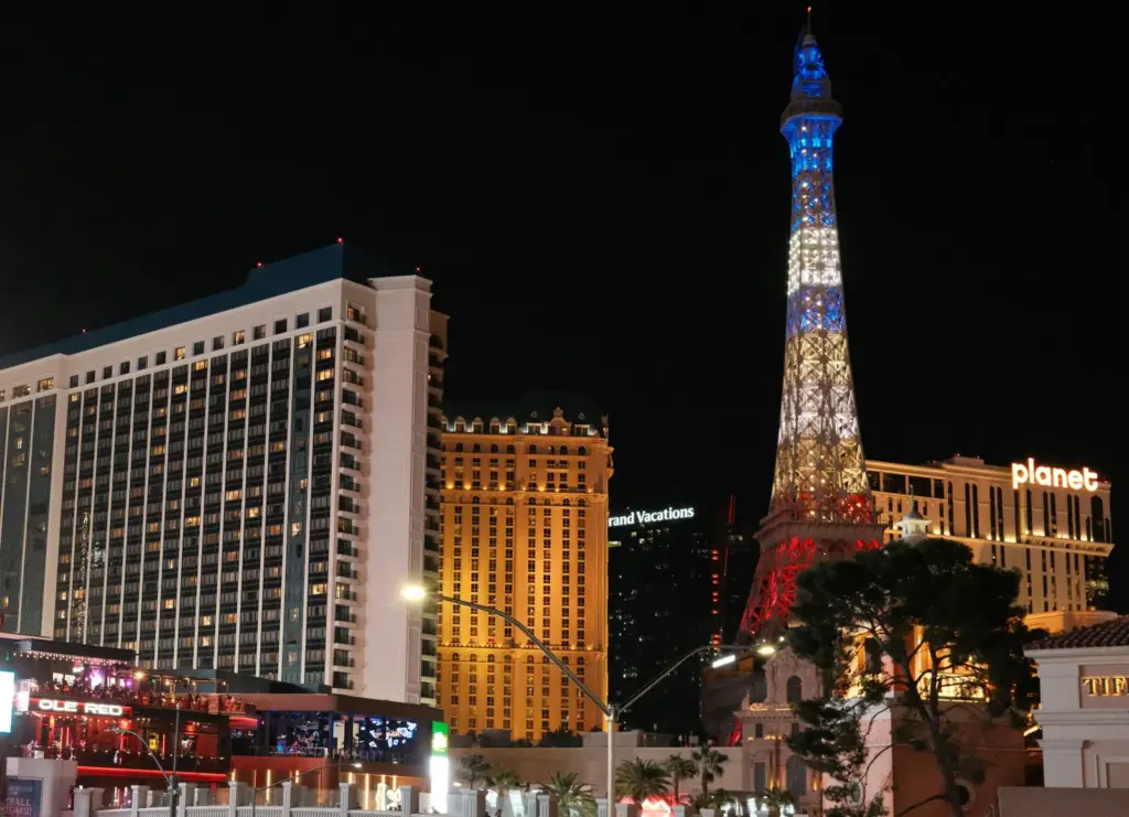 Paris Las Vegas, its Eiffel Tower replica and Planet Hollywood at night on the Las Vegas Strip