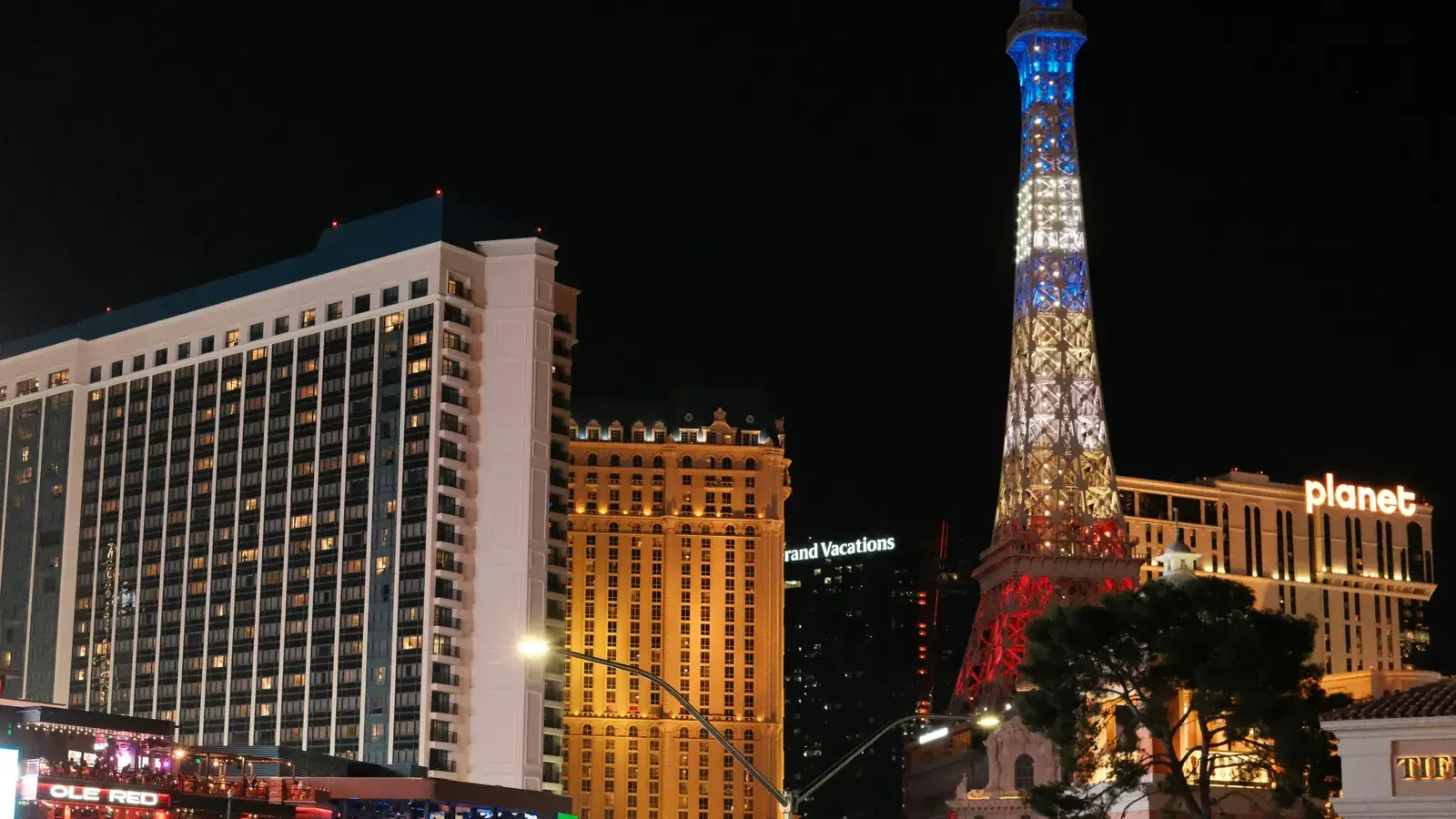 Paris Las Vegas, its Eiffel Tower replica and Planet Hollywood at night on the Las Vegas Strip