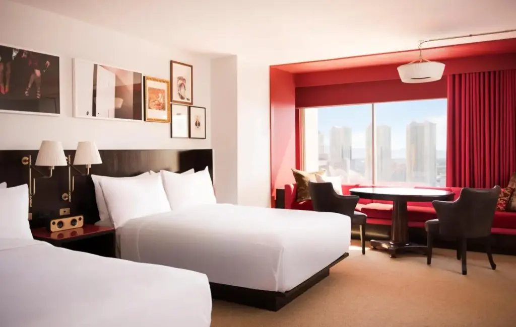 a hotel room with two beds and a table at Park MGM Las Vegas in Las Vegas