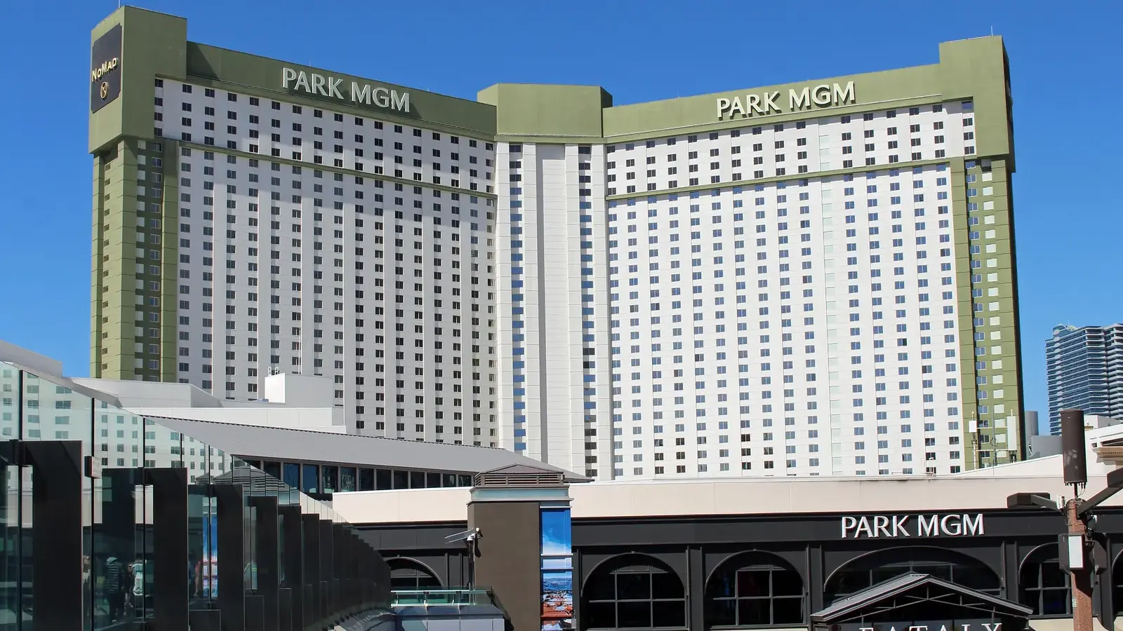 Park MGM hotel tower and Eataly entrance seen from a Strip pedestrian bridge