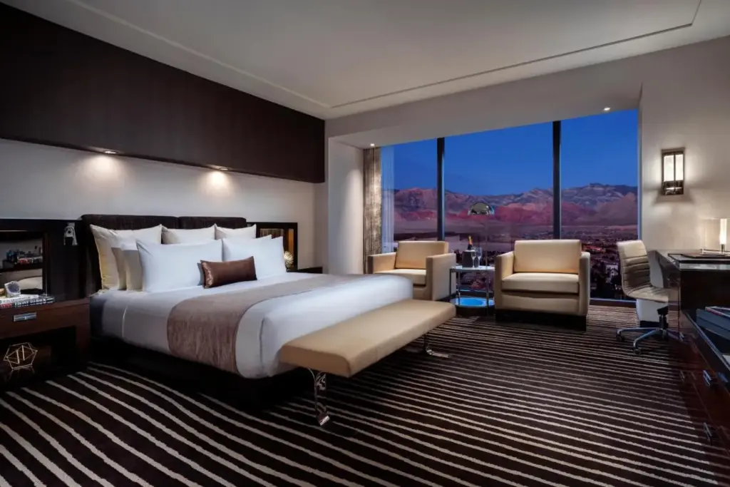 a hotel room with a bed and a desk and chairs at Red Rock Casino Resort & Spa in Las Vegas