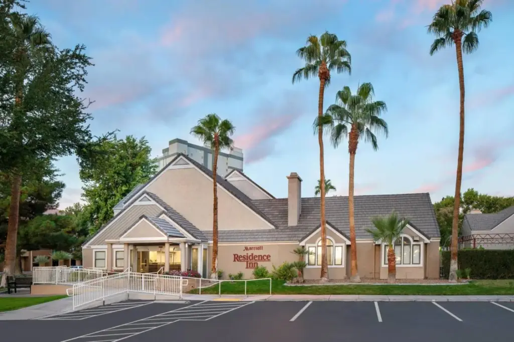 a building with palm trees in front of it at Residence Inn by Marriott Las Vegas Convention Center in Las Vegas
