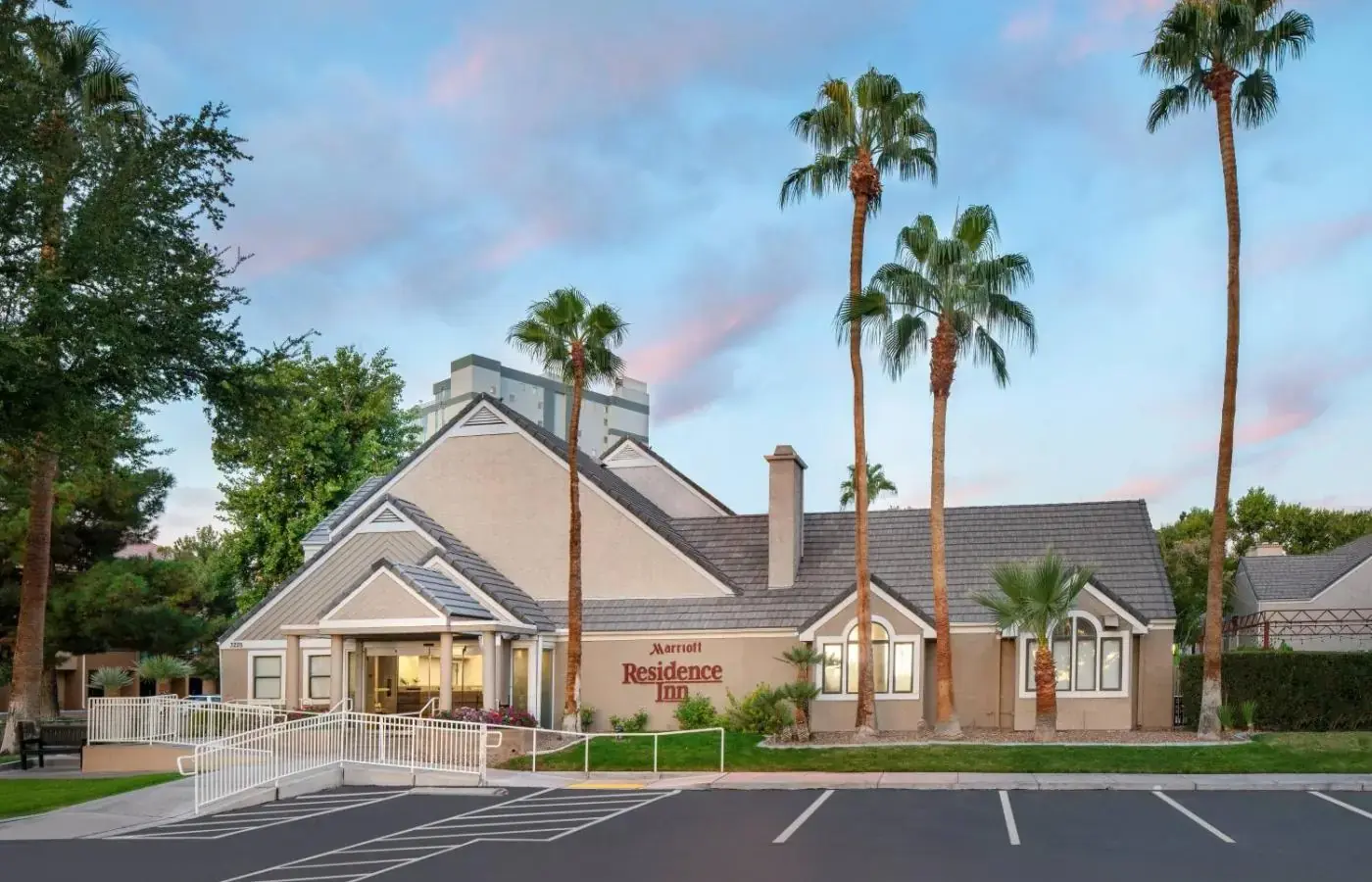 a building with palm trees in front of it at Residence Inn by Marriott Las Vegas Convention Center in Las Vegas
