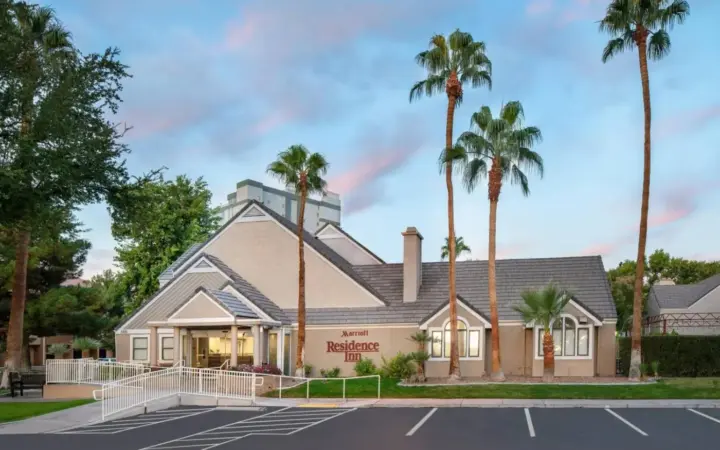 a building with palm trees in front of it at Residence Inn by Marriott Las Vegas Convention Center in Las Vegas