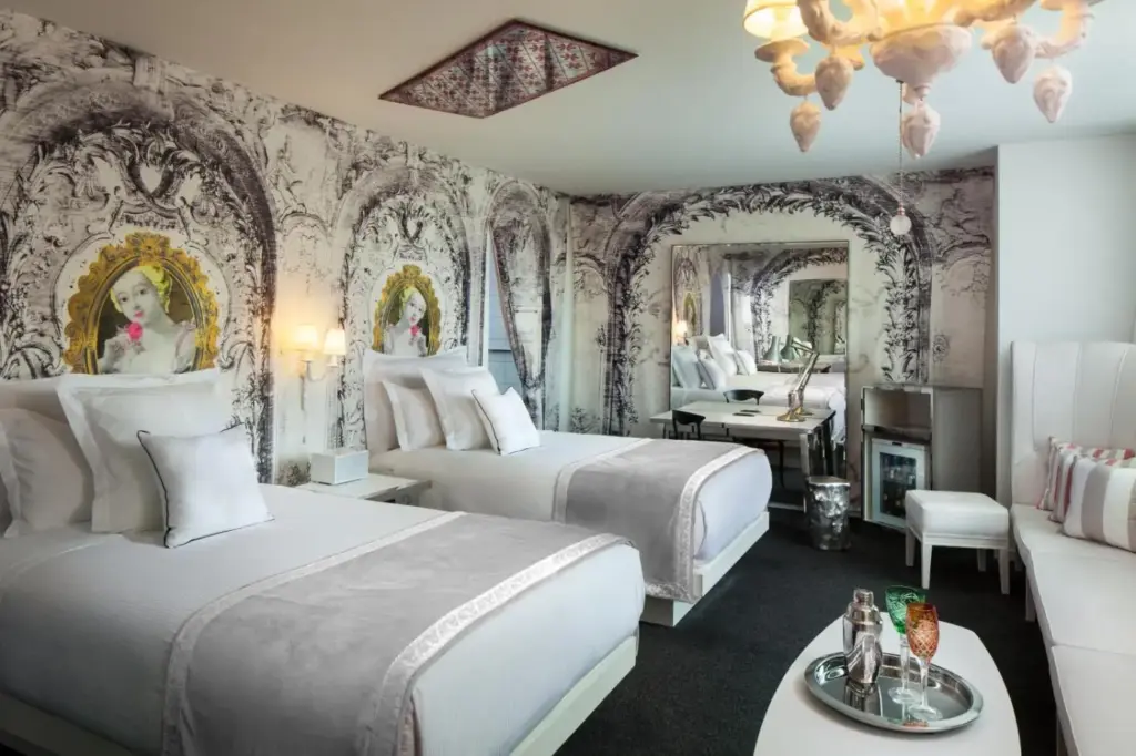 a bedroom with two beds and a living room at SAHARA Las Vegas in Las Vegas