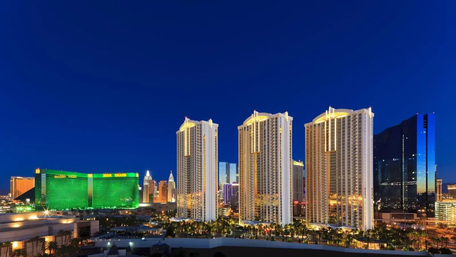 The Signature at MGM Grand towers beside MGM Grand at night