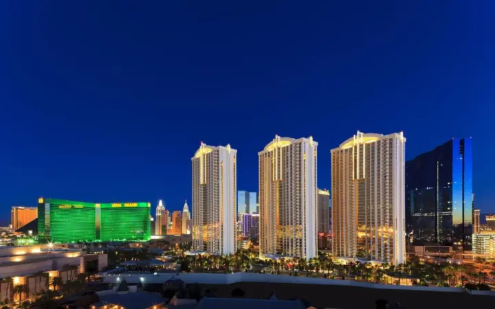 The Signature at MGM Grand towers beside MGM Grand at night