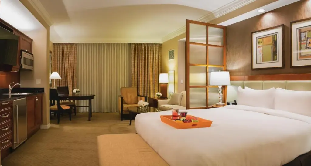 King bed and sitting area in a suite at The Signature at MGM Grand