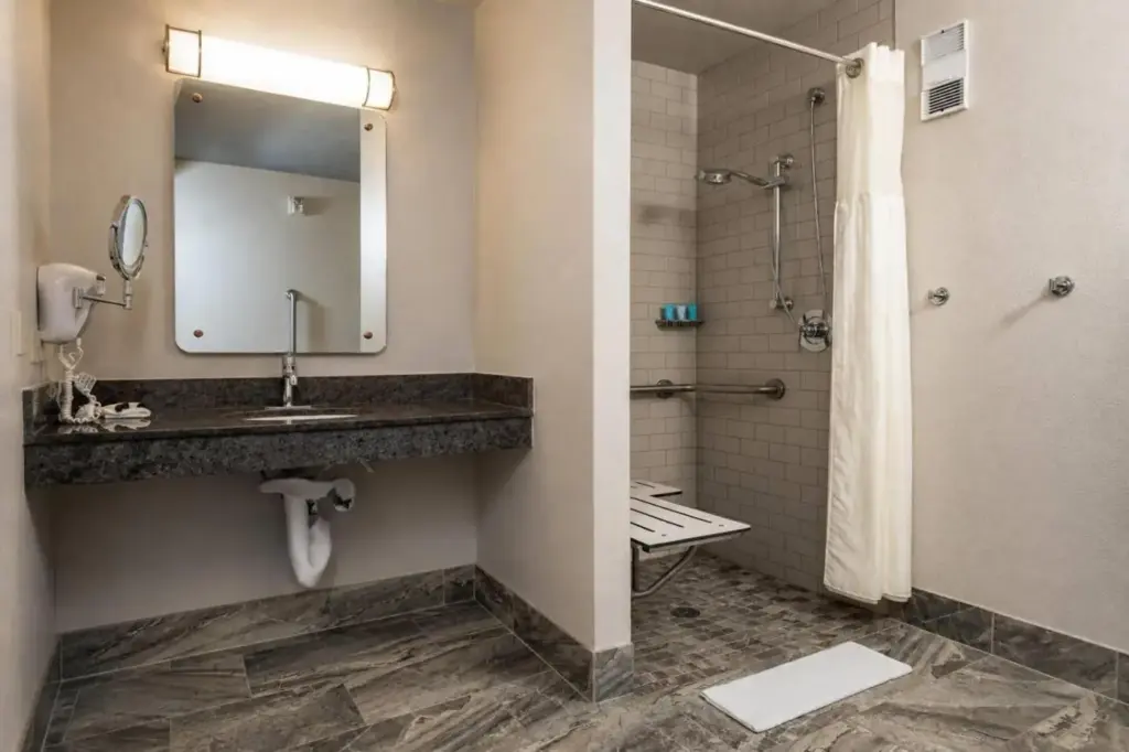 a bathroom with a sink and a shower at Silver Sevens Hotel and Casino, a Wyndham Garden in Las Vegas