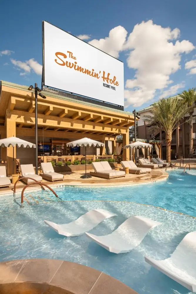 a swimming pool at a resort with chairs and a sign at Silverton Casino Lodge in Las Vegas