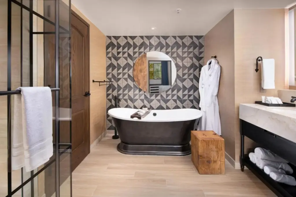 a bathroom with a bath tub and a mirror at Silverton Casino Lodge in Las Vegas