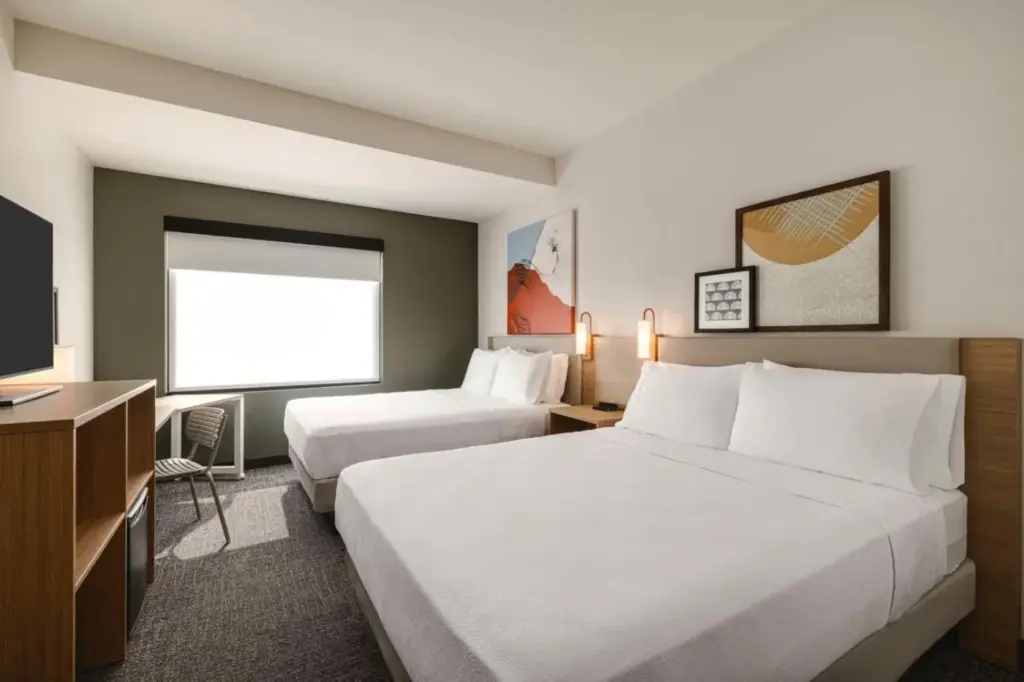 a hotel room with two beds and a television at Spark By Hilton Las Vegas Airport in Las Vegas