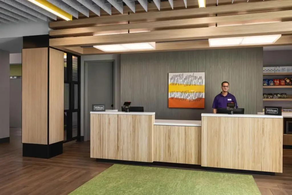 a man standing at a counter in an office lobby at Spark By Hilton Las Vegas Airport in Las Vegas