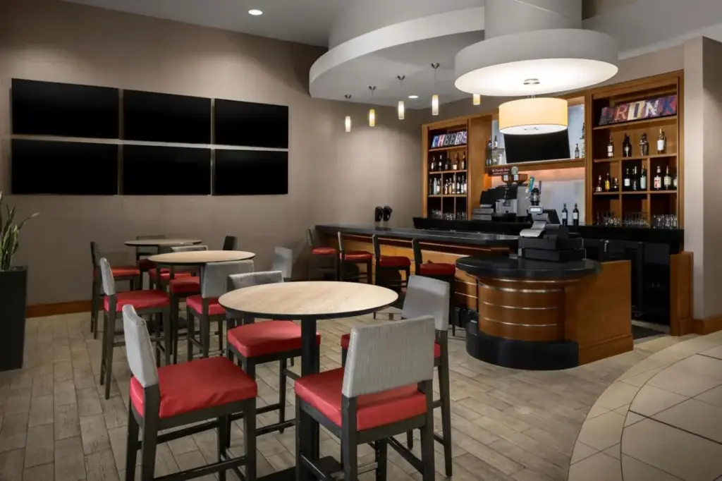a restaurant with tables and chairs and a bar at SpringHill Suites by Marriott Las Vegas Convention Center in Las Vegas