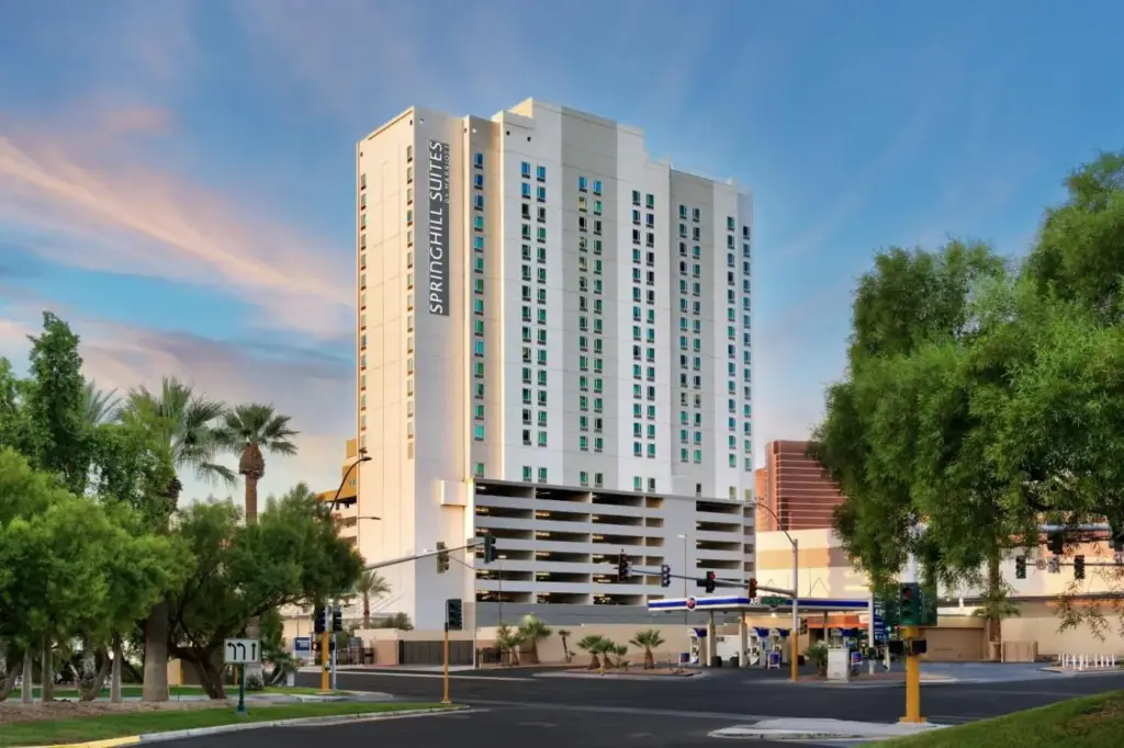 a large white building on a city street with trees at SpringHill Suites by Marriott Las Vegas Convention Center in Las Vegas