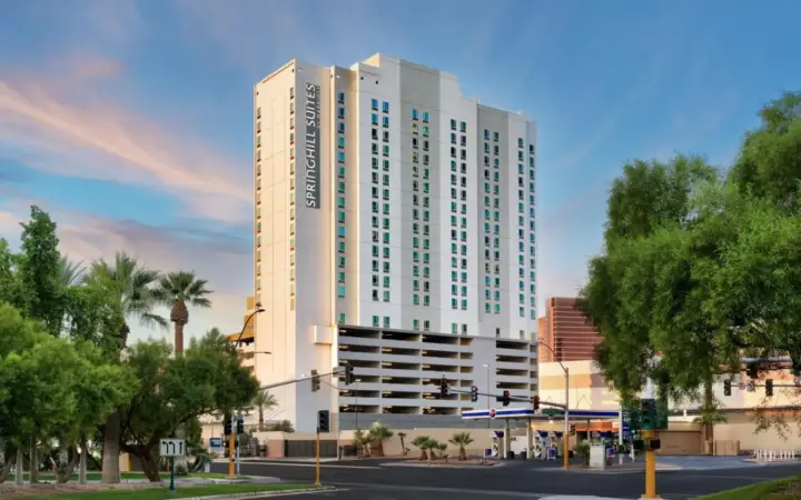 a large white building on a city street with trees at SpringHill Suites by Marriott Las Vegas Convention Center in Las Vegas