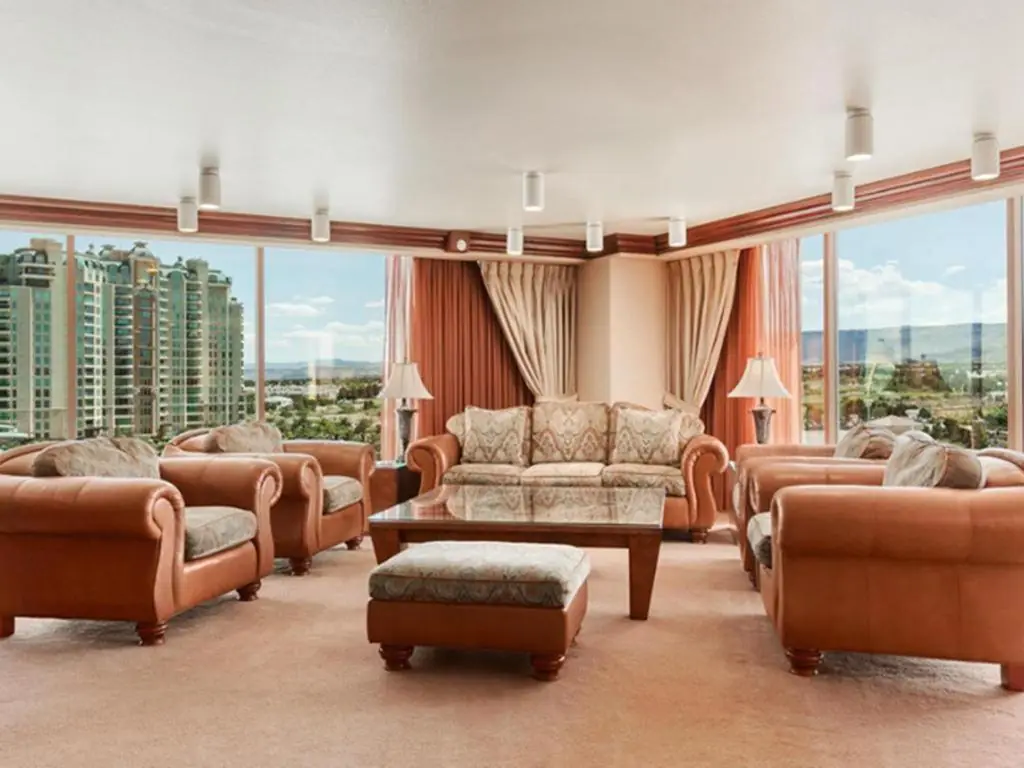 a living room with leather furniture and large windows at Suncoast Hotel and Casino in Las Vegas