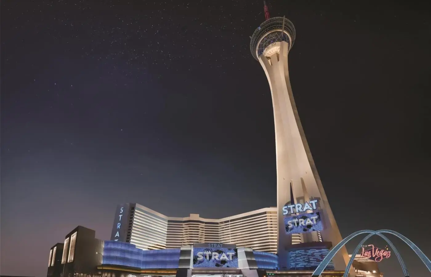 a view of a skyscraper with a tower at night at The STRAT Hotel, Casino & Tower in Las Vegas