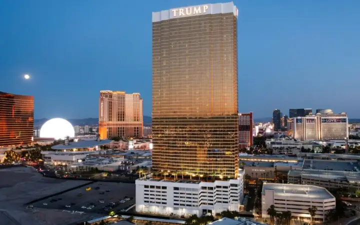 a tall building with a sign on it in a city at Trump International Hotel Las Vegas in Las Vegas