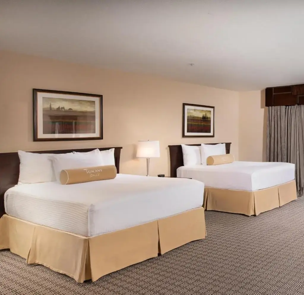 Example Tuscany Suites guest room with two beds