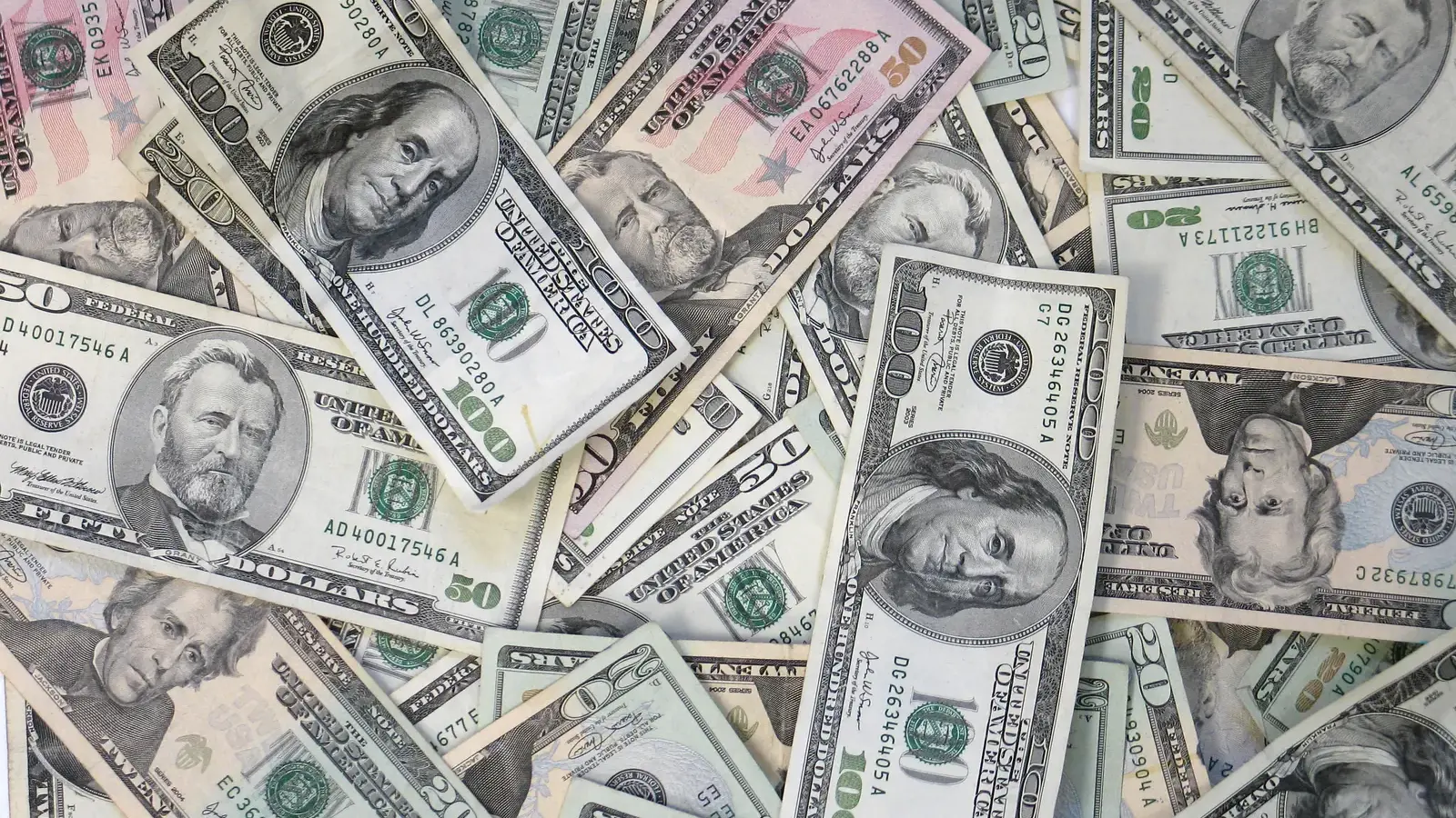 Pile of US dollar bills in various denominations