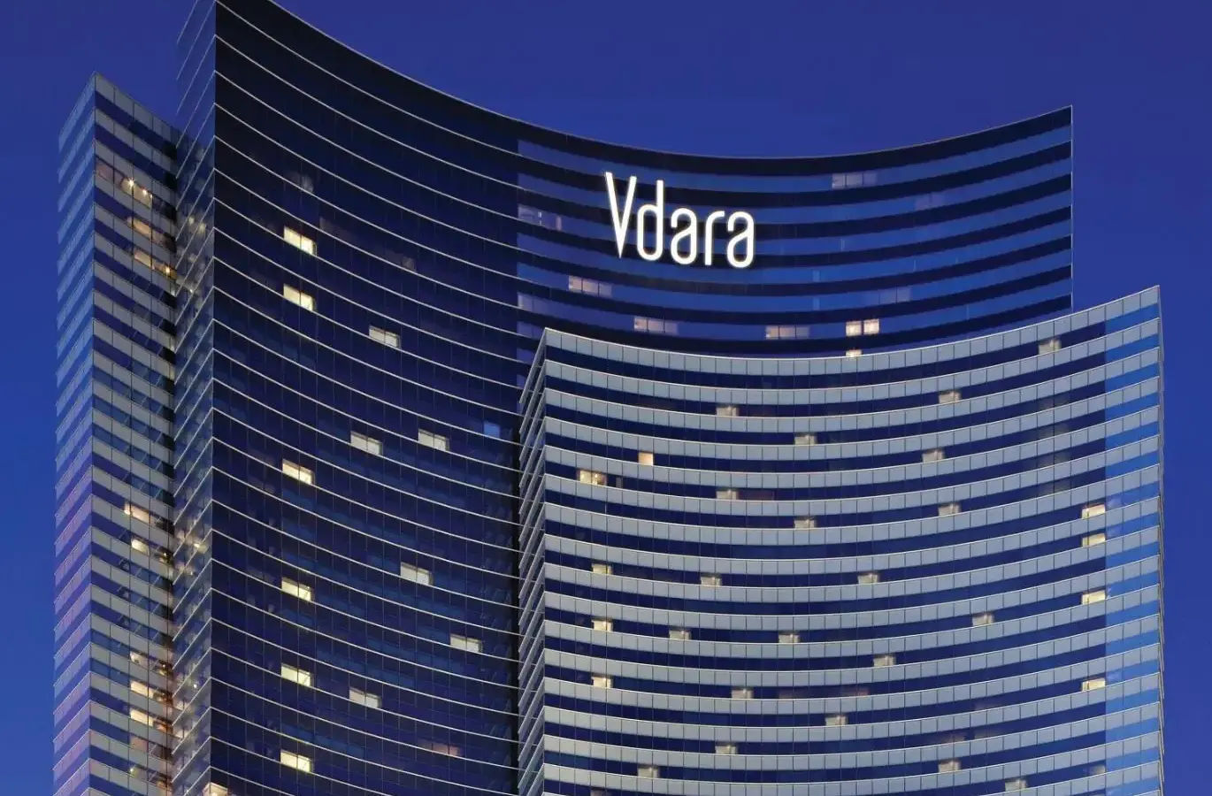 a tall building with the vida logo on it at Vdara Hotel & Spa at ARIA Las Vegas in Las Vegas